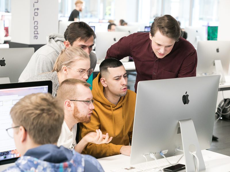 Small group of students working together on an iMac - School 21 campus (Russia)
